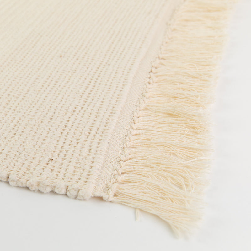 Azulina Home - Cali Bath Mat - Ivory - Hand made of 100% cotton in Colombia.  Super soft bathmat.  Close up of ivory cotton fringe.  Super soft bathmat.  Close up of ivory cotton fringe.