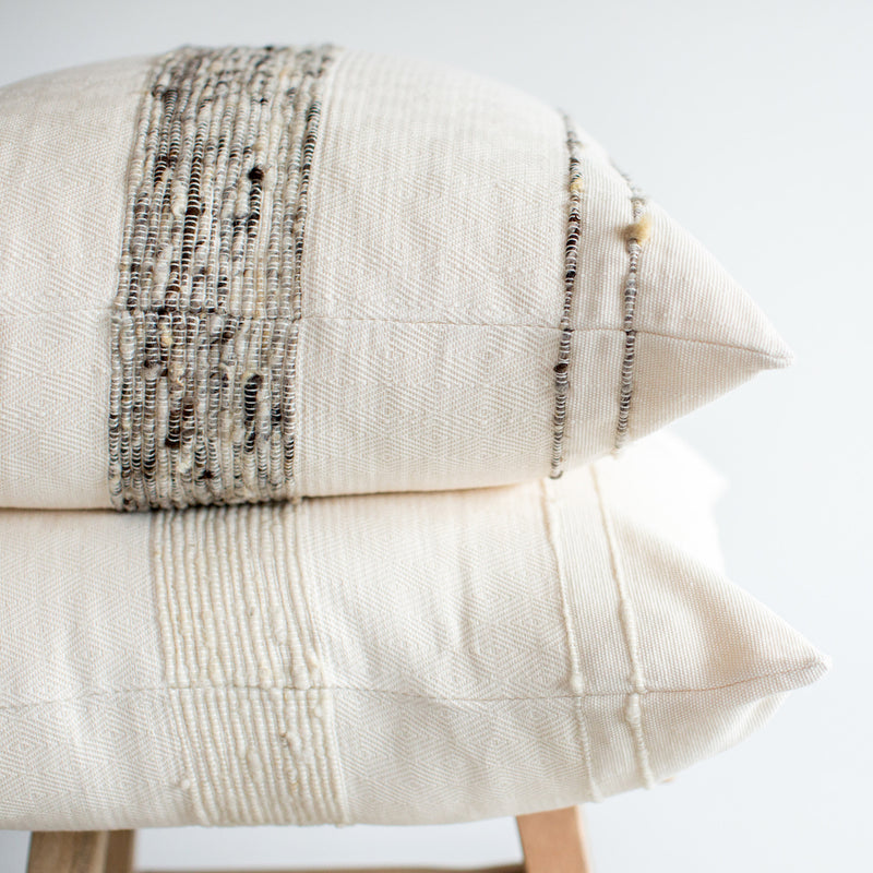Azulina Home - Bogota 24" pillow - ivory cotton with ivory wool stripes. Stripes across the pure cotton twill base create a clean-lined and versatile pattern that celebrates the natural materials. 95% cotton and 5% virgin wool, locally sourced in Colombia. Hand crafted, combining the heritage of loom weaving with modern design.